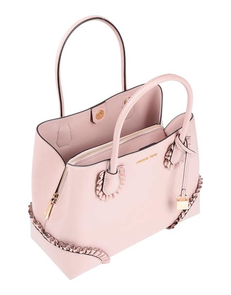 michael kors purse brown with light pink accents|Michael Kors pink studded purse.